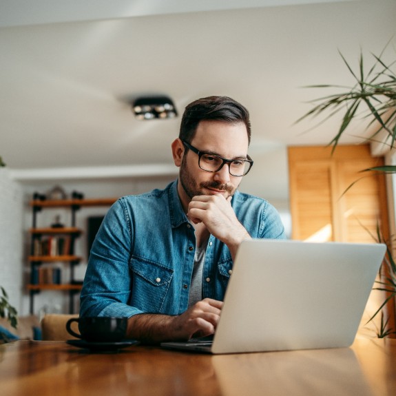 Mann arbeitet am Laptop